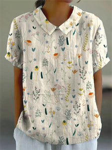 Short-sleeved blouse featuring a vibrant floral pattern, perfect for casual outings or summer events. 1