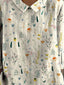 Short-sleeved blouse featuring a vibrant floral pattern, perfect for casual outings or summer events. 2