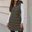 Longline puffer vest worn over a knit