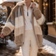 Faux fur coat worn open over jeans