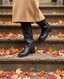 Black leather knee-high boots on autumn steps, Lauren Boutique boots