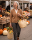 Woman in a camel knit cardigan at an autumn market