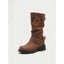 Black biker boots worn on a city street