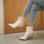 Beige ankle boots styled with light denim