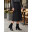 Black cap toe boots worn with a midi skirt
