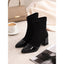 Cap toe ankle boots styled with a handbag