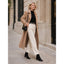 Black ankle boots worn with a long coat