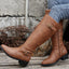 Light brown riding boots worn with jeans