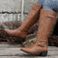 Tan riding boots shown against a wall