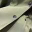 Detail of the buttons on the green trench coat