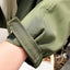 Detail of the cuff on the green trench coat