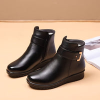 Black buckle ankle boots worn with jeans
