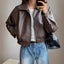 Front view of the dark brown cropped faux leather bomber jacket