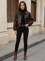 Brown leather jacket worn with black trousers