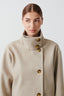 Detail of the gold buttons on the beige peacoat