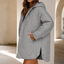 Gray quilted puffer jacket worn open over a knit