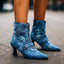 Denim heeled boots worn on a city street