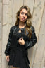 Black bomber jacket worn with a black top