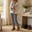Brown ankle boots styled with a cream knit at home