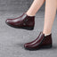 Wine red winter ankle boots worn on the foot