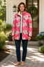 Printed jacket worn open over a tee