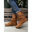 Beige fringe boots seen close up