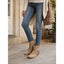 Beige fringe boots worn with jeans