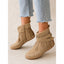Fringe boots worn with wide leg trousers