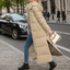 Beige maxi puffer coat worn with boots