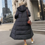 Black maxi puffer coat with the hood up