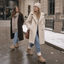 Tan fur lined winter boots worn with a long coat