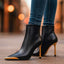 Black stiletto ankle boots worn with jeans at night