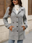 Grey herringbone coat worn buttoned up