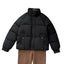 Black padded jacket worn with brown trousers