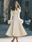 Full length view of the ivory flared coat with faux fur trim