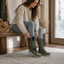 Winter boots worn on a doorstep with jeans