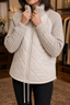 Knit panel puffer jacket worn with jeans