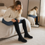 Lace-up over the knee boots styled with a knit sweater