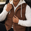 Double hood puffer vest worn over a knit