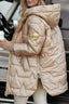 Beige satin puffer jacket with the hood up