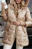 Beige satin puffer jacket worn with the hood down