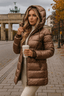 Women's long quilted puffer jacket with oversized hood in coffee brown