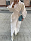 White duster coat worn open on the street