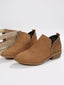 Perforation detail on the brown ankle boots