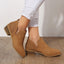 Brown perforated ankle boots worn with jeans