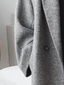 Detail of the textured wool blend on the grey coat