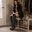 Snow boots styled with a black coat indoors