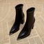 Black pointed toe ankle boots shown as a pair
