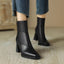 Black ankle boots worn with jeans