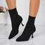 Black sock style ankle boots on the foot